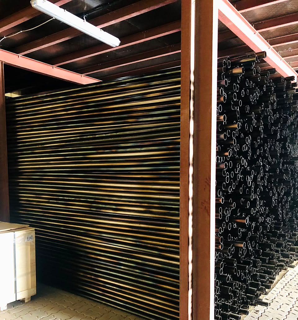 Hundreds of 50 mm sonic pipes stacked on racks in the MAF warehouse