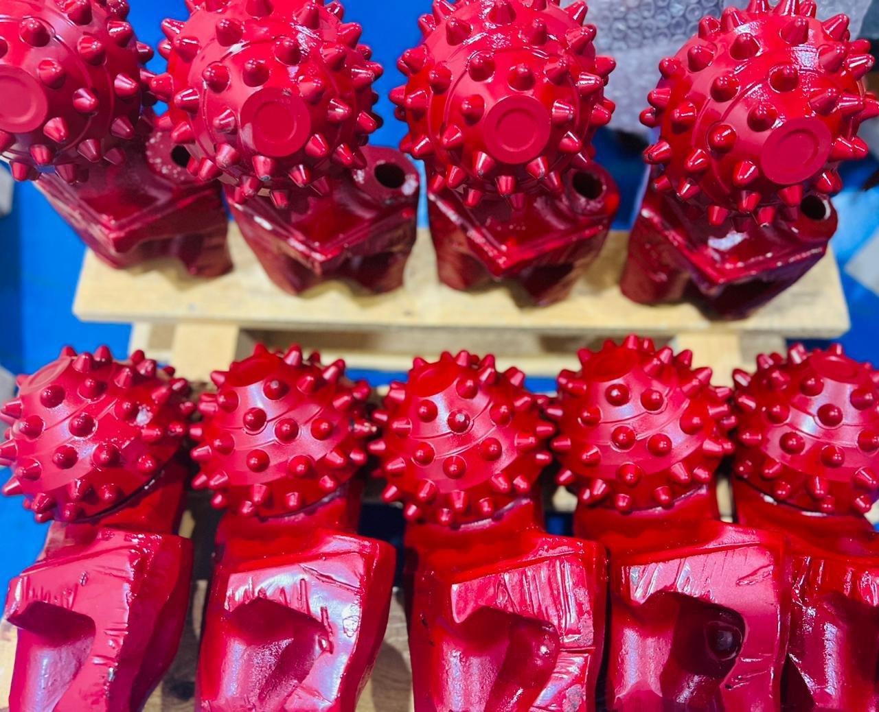 Rows of red tricone rock bits in the MAF warehouse